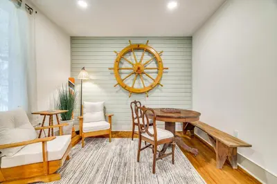 a dining room with a table and a steering wheel on the wall at Hot Tub and Lake Access at Poconos Getaway! in Lake Ariel