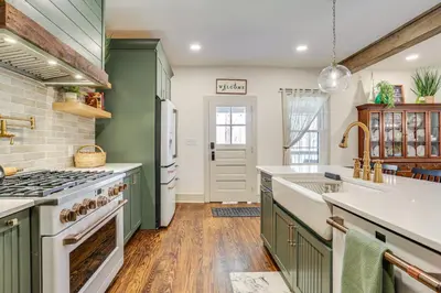 a kitchen with green cabinets and white appliances at Hot Tub and Lake Access at Poconos Getaway! in Lake Ariel