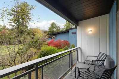 a balcony with two chairs and a view of a yard at Hotel Vervana, Trademark Collection by Wyndham in Bennington