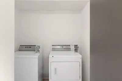 a laundry room with a washer and dryer at Hotel Vervana, Trademark Collection by Wyndham in Bennington