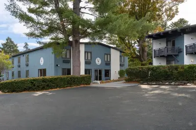 a building with a parking lot in front of it at Hotel Vervana, Trademark Collection by Wyndham in Bennington