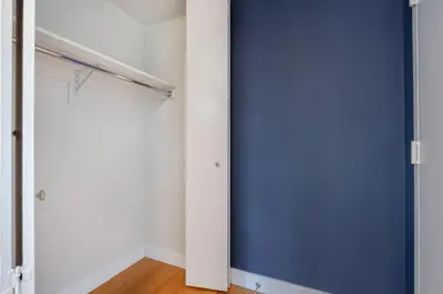 a closet with a blue door and white walls at Modern Bright Times Sq 1BR w Indoor pool NYC-8 in New York