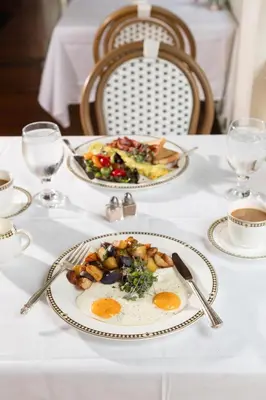 a white table with two plates of food on it at Saratoga Arms Hotel in Saratoga Springs