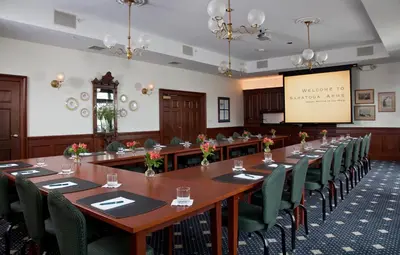 a conference room with a long table and chairs at Saratoga Arms Hotel in Saratoga Springs
