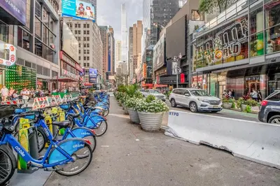 a row of blue bikes parked on a city street at Sq 1BR w Great views Indoor pool NYC-29 in New York