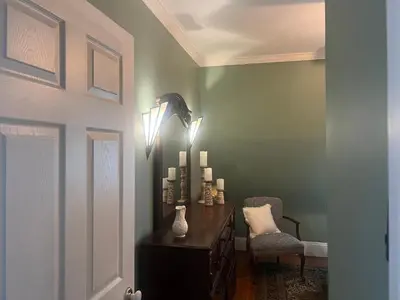 a room with a desk with a chair and lights at 2Br Private Victorian Apartment in City location on half acre Sleeps 5 in Poughkeepsie