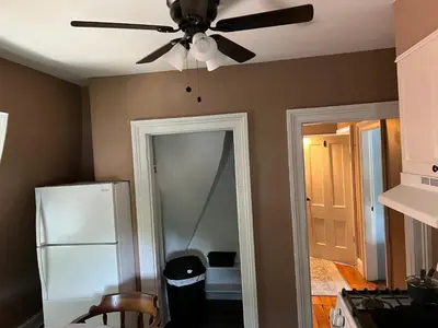 a kitchen with a ceiling fan and a mirror at 2Br Private Victorian Apartment in City location on half acre Sleeps 5 in Poughkeepsie