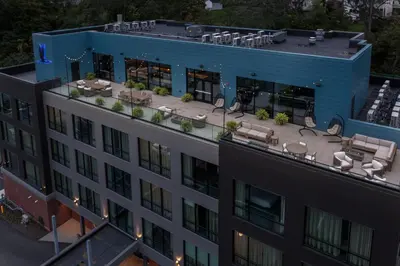 an aerial view of a building with a patio at voco James Newbury Hudson Valley by IHG in Coxsackie