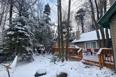 a house with a yard covered in snow at Family retreat, Closest Rental House to POOL & BEACH, Hot tub, Game Room in Tobyhanna