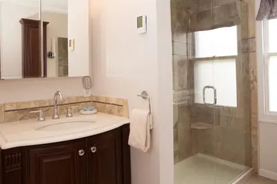 a bathroom with a sink and a shower at Knotty Pine Motel in Bennington