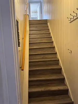 a staircase in a school with wooden floors at Knotty Pine Motel in Bennington