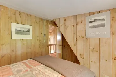 a bedroom with wood paneled walls and a bed at Serene Salisbury Rental Home on 26 Acres with Deck! in Salisbury