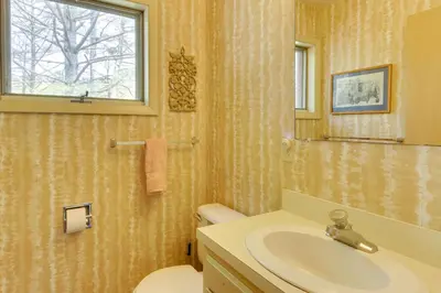 a bathroom with a sink and a toilet and a window at Serene Salisbury Rental Home on 26 Acres with Deck! in Salisbury