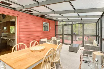 a dining room with a wooden table and chairs at Serene Salisbury Rental Home on 26 Acres with Deck! in Salisbury