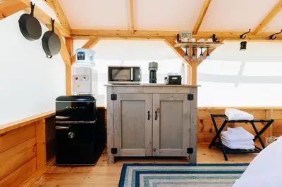 a kitchen with a refrigerator and a microwave in a room at Battenkill Glamping Resort in Cambridge
