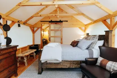 a bedroom with a king sized bed in a cabin at Battenkill Glamping Resort in Cambridge