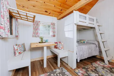 a bedroom with a bunk bed and a desk at Battenkill Glamping Resort in Cambridge