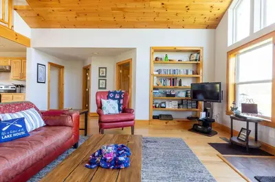 a living room with a couch and a table at Silver Lake Cabin w/ Own Lake! (near Cooperstown) in New Berlin