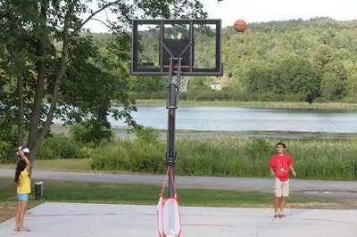 two children playing a game of a basketball hoop at Silver Lake Cabin w/ Own Lake! (near Cooperstown) in New Berlin