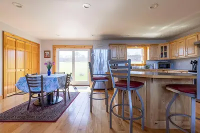 a kitchen with a table and chairs in a kitchen at Silver Lake Cabin w/ Own Lake! (near Cooperstown) in New Berlin