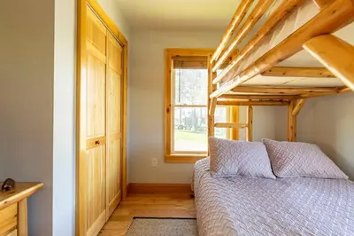 a bedroom with a bunk bed and a window at Silver Lake Cabin w/ Own Lake! (near Cooperstown) in New Berlin