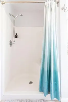 a shower with a blue shower curtain in a bathroom at Silver Lake Cabin w/ Own Lake! (near Cooperstown) in New Berlin
