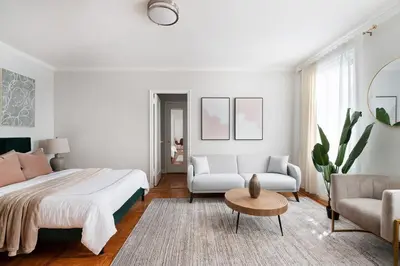 a white bedroom with a white bed and a couch at 105 -5G Brand New Studio prime location Elevator in New York