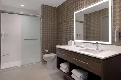 a bathroom with a toilet and a sink and a shower at Home2 Suites By Hilton Bristol in Bristol