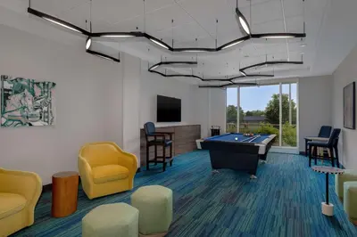 a waiting room with a pool table and chairs at Home2 Suites By Hilton Bristol in Bristol