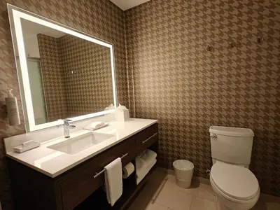 a bathroom with a sink and a toilet and a mirror at Home2 Suites By Hilton Bristol in Bristol