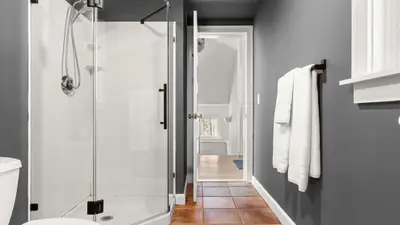 a bathroom with a shower with a glass door at Hupi House - A Peaceful Wooded Lakeside Retreat in Monterey