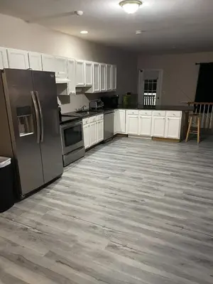 a kitchen with stainless steel appliances and white cabinets at Private Apartment in Southbury 101 in Southbury