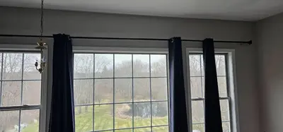 a living room with two windows with black curtains at Private Apartment in Southbury 101 in Southbury