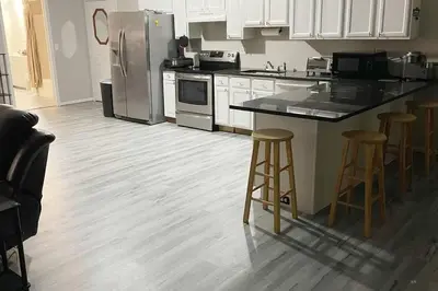 a kitchen with a refrigerator and bar stools in it at Private Apartment in Southbury 101 in Southbury