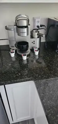 a kitchen with a coffee maker and cups on a counter at Private Apartment in Southbury 101 in Southbury