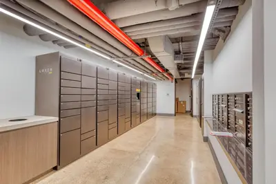 a long hallway with a row of lockers in a building at Midtown East 2br w gym wd nr Grand Central NYC-1146 in New York