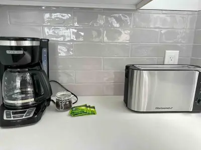 a kitchen counter with a coffee maker and a toaster at Secret Escape 20 Min from NYC N 1 in Jersey City