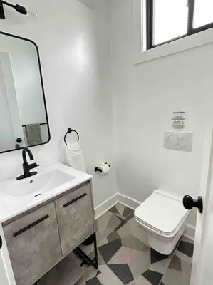 a bathroom with a sink and a toilet and a mirror at Secret Escape - 20 min from NYC N 2 in Jersey City