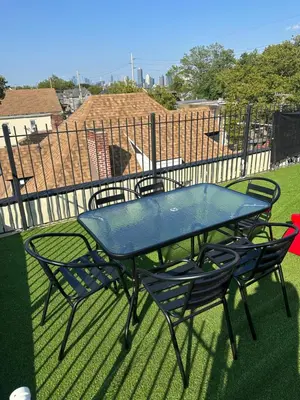 a blue table and chairs sitting on a patio at Secret Escape - 20 min from NYC N 2 in Jersey City