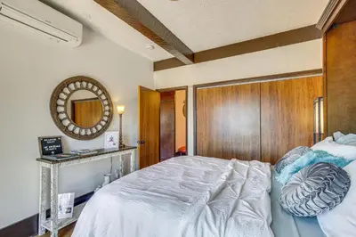 a bedroom with a bed with a wooden headboard and a mirror at East Fishkill Escape, Close to Red Wing Park! in Hopewell Junction