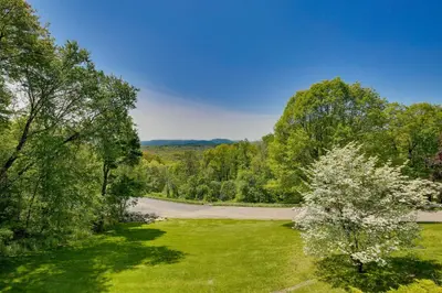 an empty road in the middle of a field with trees at East Fishkill Escape, Close to Red Wing Park! in Hopewell Junction