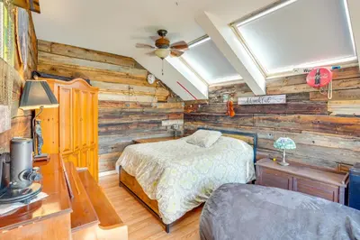 a bedroom with a bed in a room with wooden walls at Windham Mountain Vacation Rental about 3 Mi to Lifts! in Windham