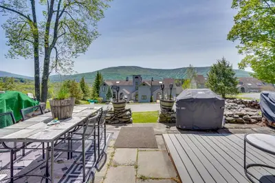 a patio with a table and chairs and a house at Windham Mountain Vacation Rental about 3 Mi to Lifts! in Windham