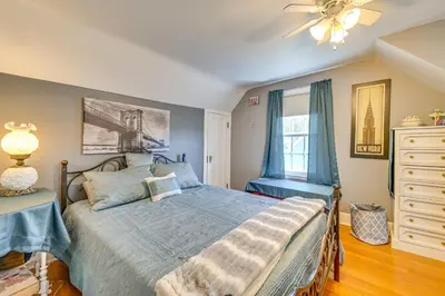 a bedroom with a bed and a ceiling fan at Pet-Friendly Gloversville Cottage Near Golf Course in Gloversville