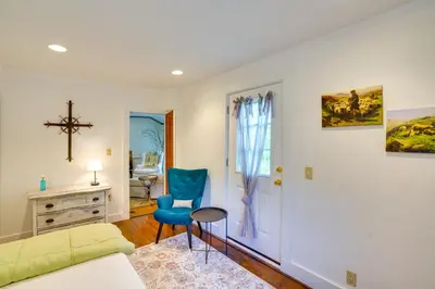 a living room with a bed and a blue chair at Family Ski Getaway 6 Mi to Berkshire East! in Hawley