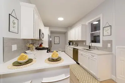a kitchen with white cabinets and white counter tops at The East Rock, 4BR, On-site Parking, Washer & Dryer, Walk to Yale in New Haven