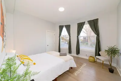 a white bedroom with a bed and a window at The East Rock, 4BR, On-site Parking, Washer & Dryer, Walk to Yale in New Haven