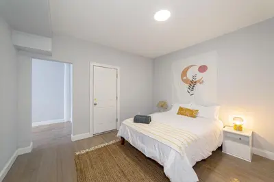 a white bedroom with a bed and a window at The East Rock, 4BR, On-site Parking, Washer & Dryer, Walk to Yale in New Haven