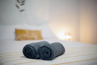a pair of towels sitting on a bed at The East Rock, 4BR, On-site Parking, Washer & Dryer, Walk to Yale in New Haven