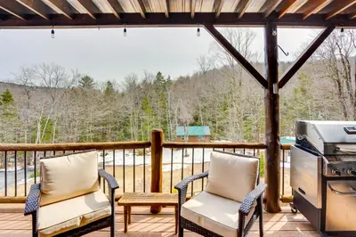 a screened in porch with two chairs and a grill at Massachusetts Vacation Rental with Deck and Grill in Cheshire